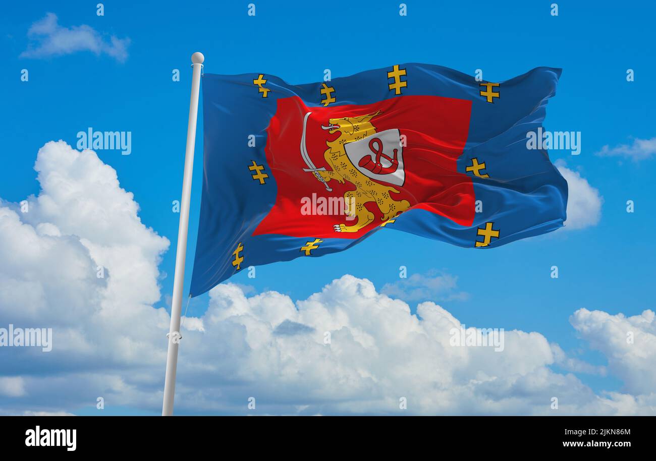 official flag of Taurage County lithuania at cloudy sky background on sunset, panoramic view. lithuanian travel and patriot concept. copy space for wi Stock Photo