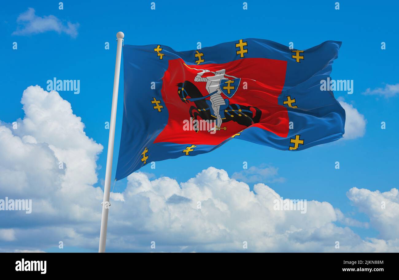 official flag of Vilnius County lithuania at cloudy sky background on sunset, panoramic view. lithuanian travel and patriot concept. copy space for wi Stock Photo
