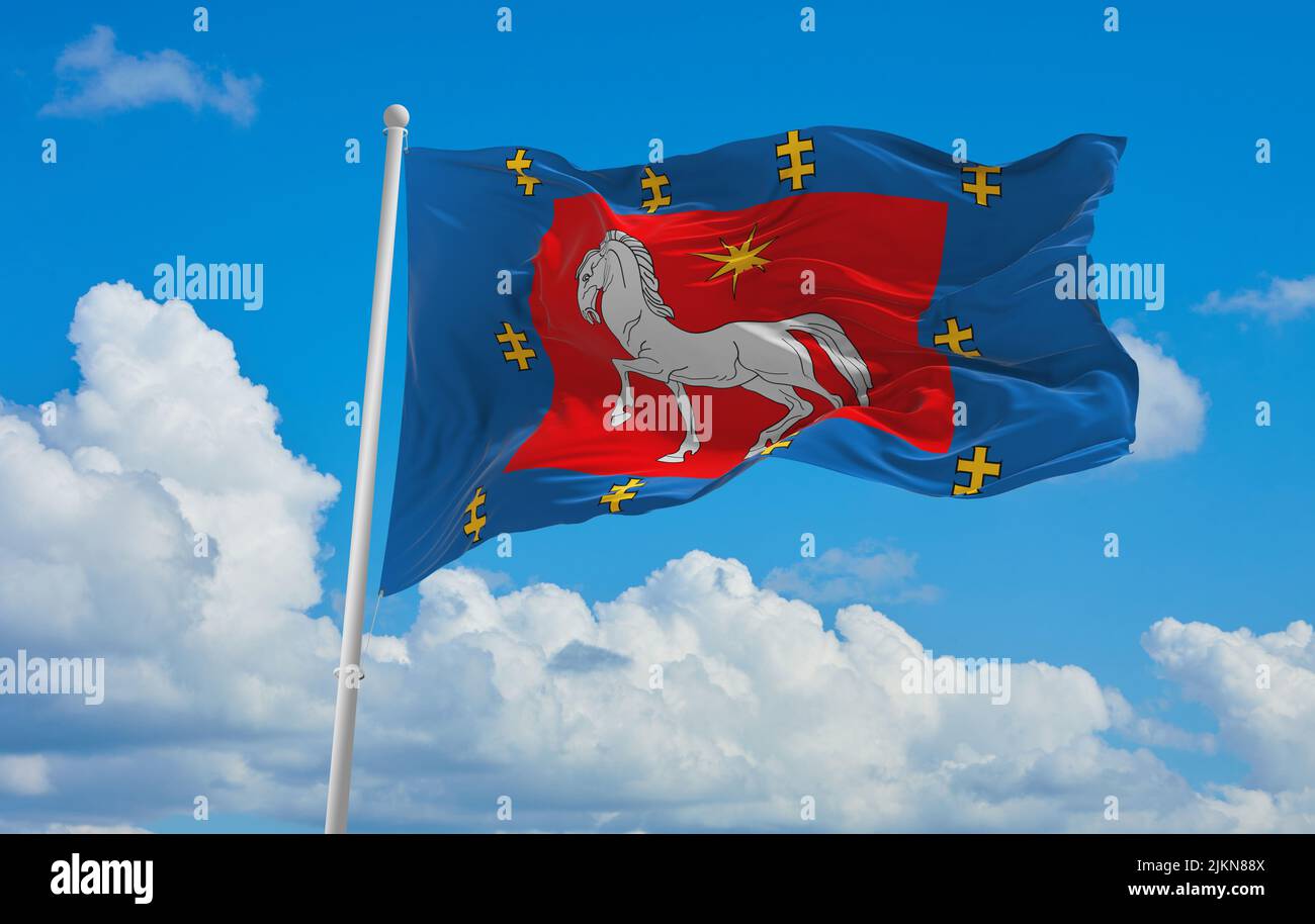 official flag of Utena County lithuania at cloudy sky background on sunset, panoramic view. lithuanian travel and patriot concept. copy space for wide Stock Photo
