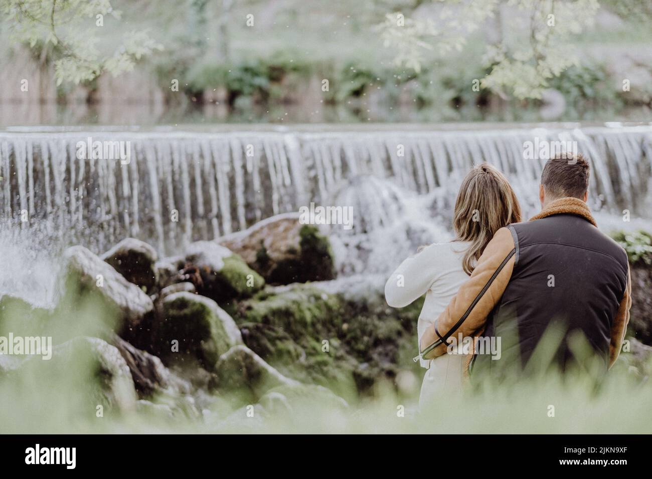 Young couple hugging riverside hi-res stock photography and images - Alamy