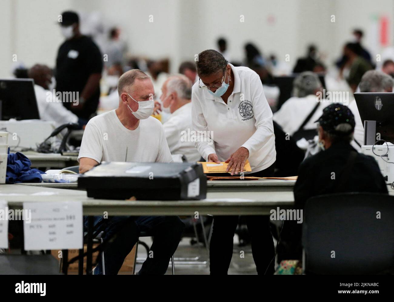 Election workers prepare absentee ballots for counting at Huntington Place during the primary election in Detroit, Michigan, U.S. August 2, 2022.  REUTERS/Rebecca Cook Stock Photo