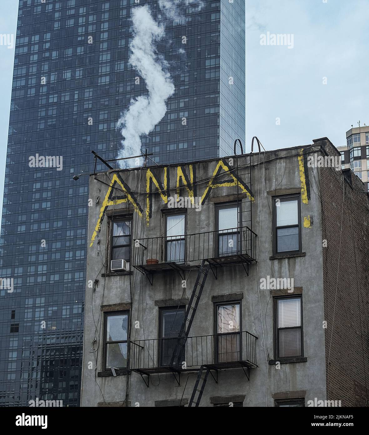 A vertical shot of name Anna graffiti on a midtown residential building in NY Stock Photo