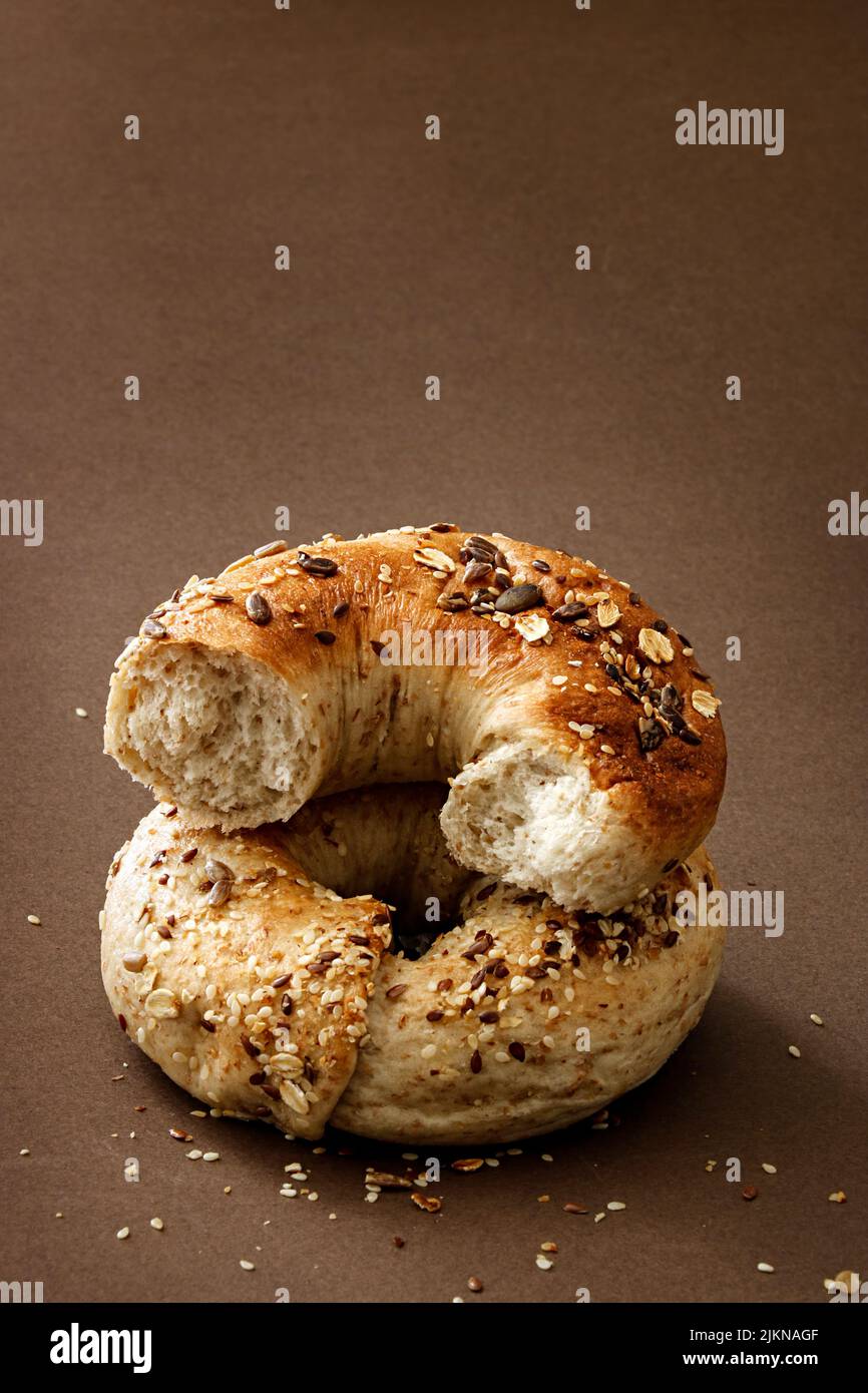 A closeup shot of fresh bread bagel rolls with seeds on a table Stock Photo
