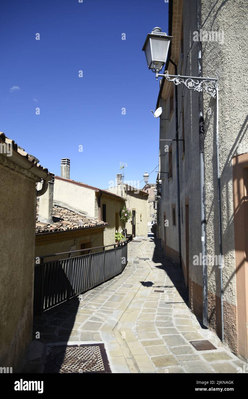 A vertical shot of a narrow street in Calvello village in the ...