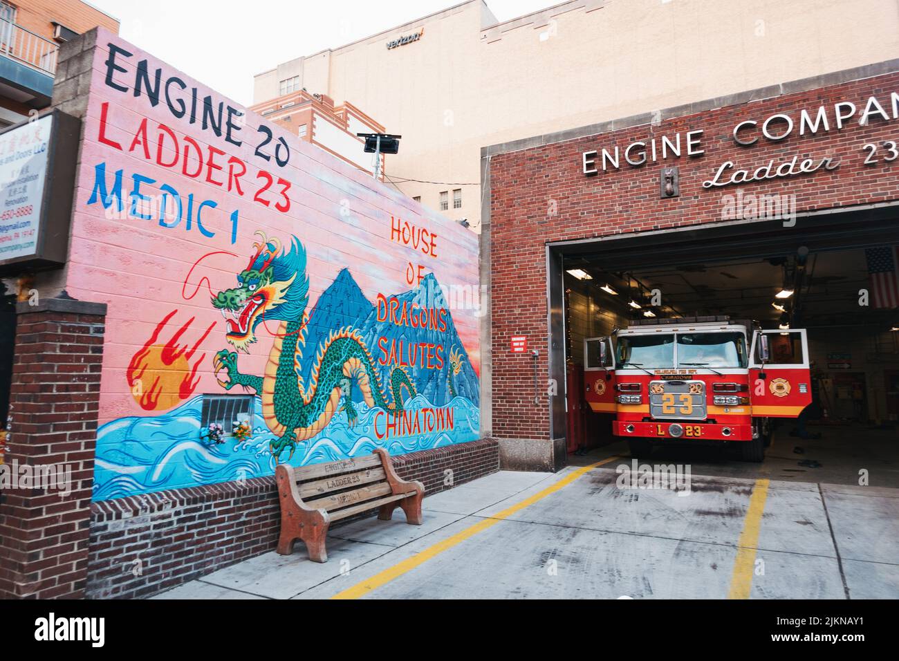 Ladder 23 fire truck inside the Philadelphia Fire Department Chinatown station, replete with a street art dragon Stock Photo