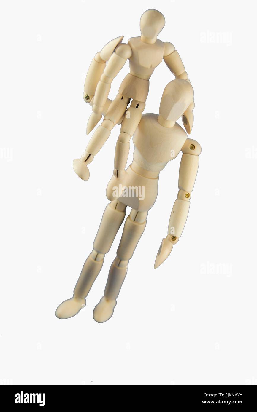 Two handmade wooden mannequins on white background Stock Photo