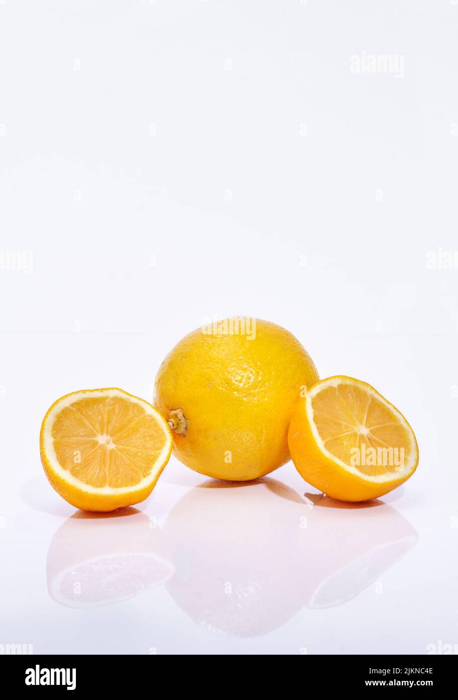 Whole and sliced lemon slices on  white background Stock Photo