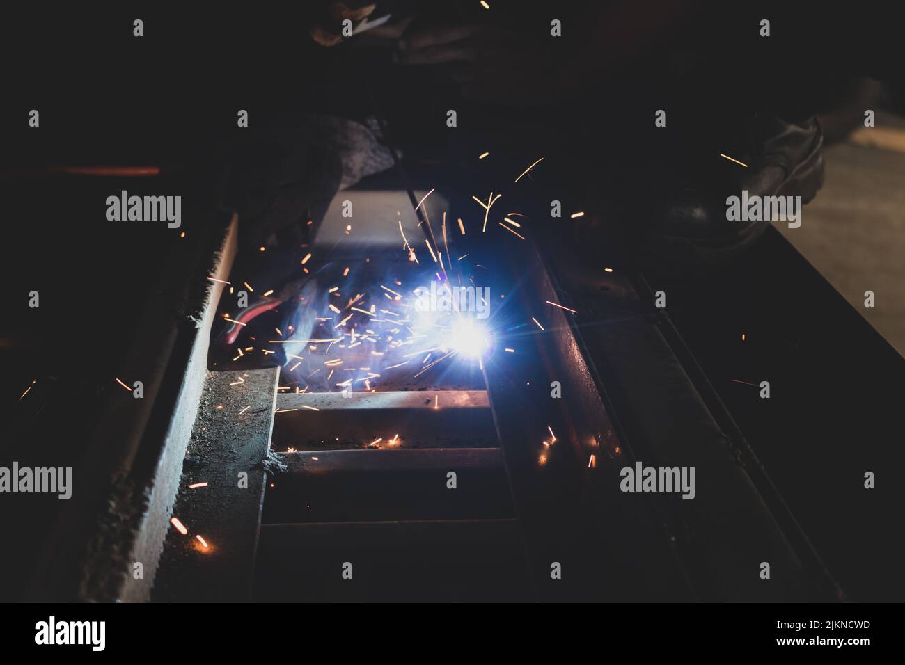 A process of arc welding for car assemble with sparks in the dark Stock