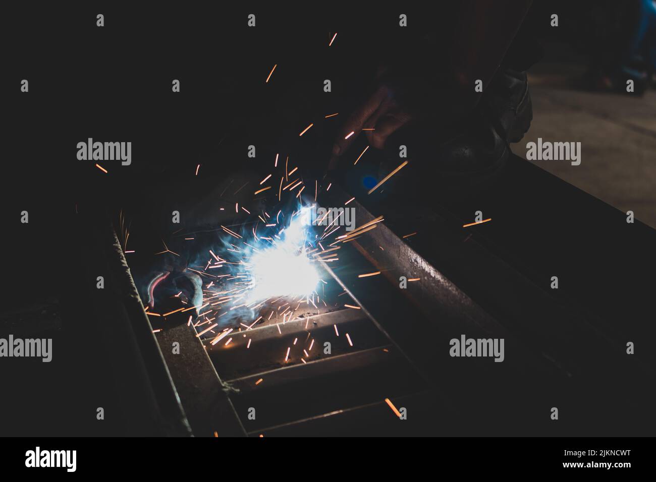 A process of arc welding for car assemble with sparks in the dark Stock