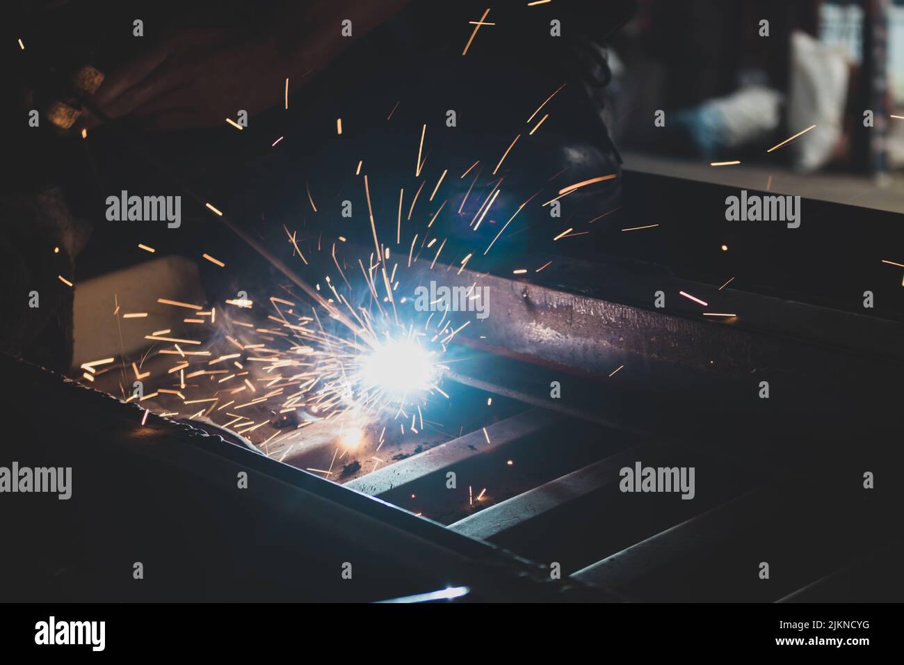 A process of arc welding for car assemble with sparks in the dark Stock