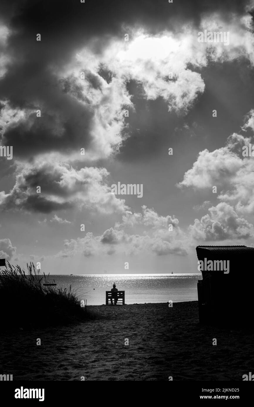A grayscale of a beach on a cloudy morning Stock Photo