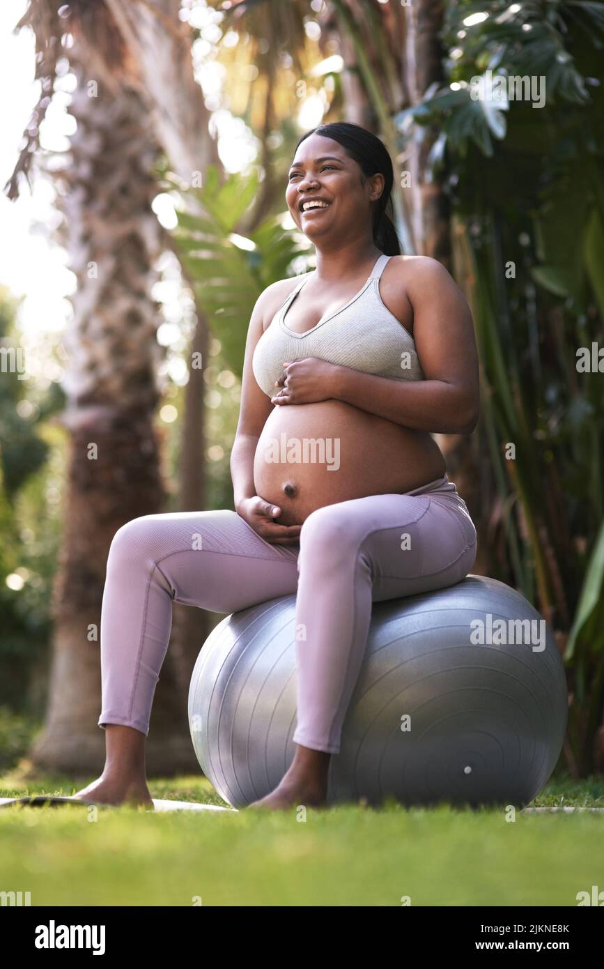 Woman sitting on stability ball hi res stock photography and