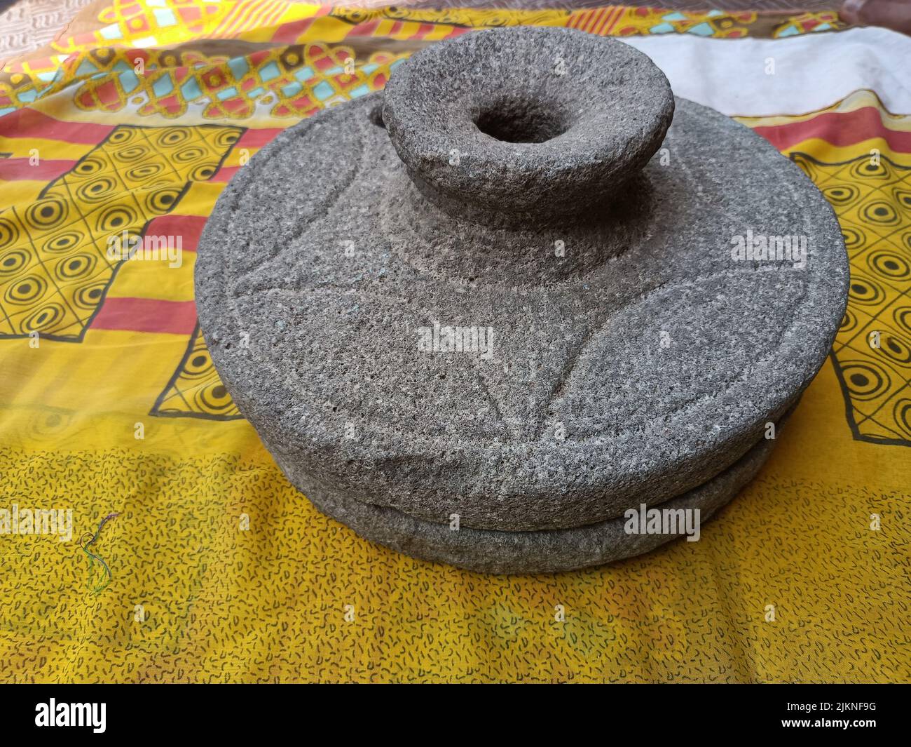 ancient hand mill or quern stone, grinds the grain into flour. Old