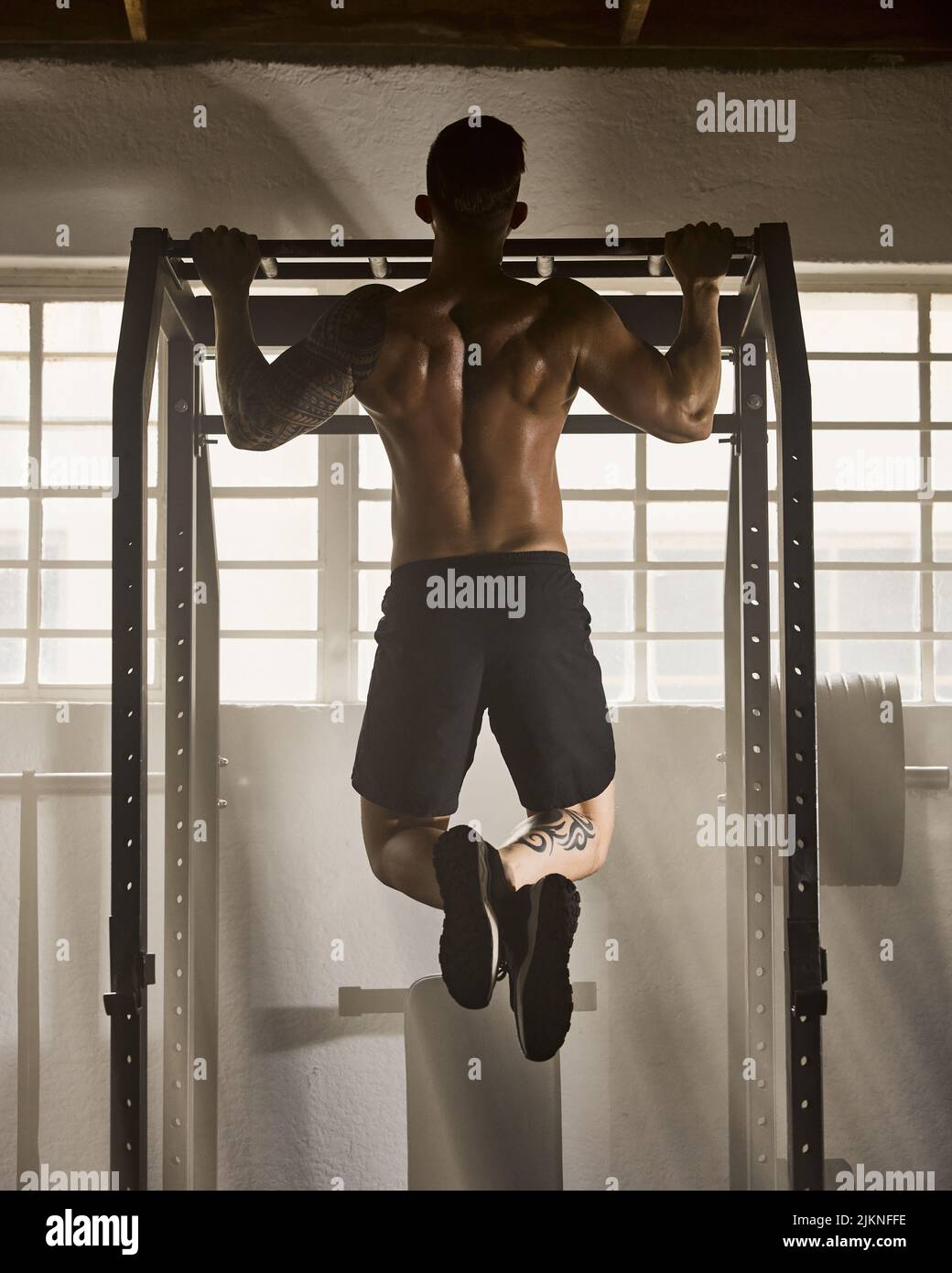 Strong, fitness and active man doing pull up strength and muscle full