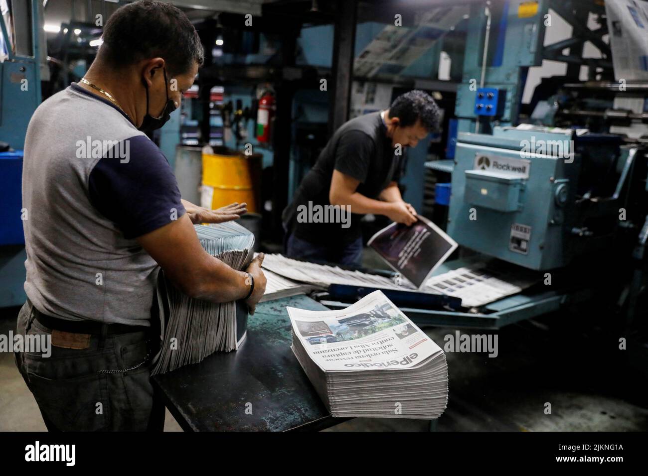 Employees print copies at the facility of the elPeriodico newspaper, an outlet famous for investigations that have revealed several cases of government corruption, following the detention of its founder Jose Ruben Zamora Marroquin by Guatemalan authorities, in Guatemala City, Guatemala, August 2, 2022. REUTERS/Luis Echeverria Stock Photo