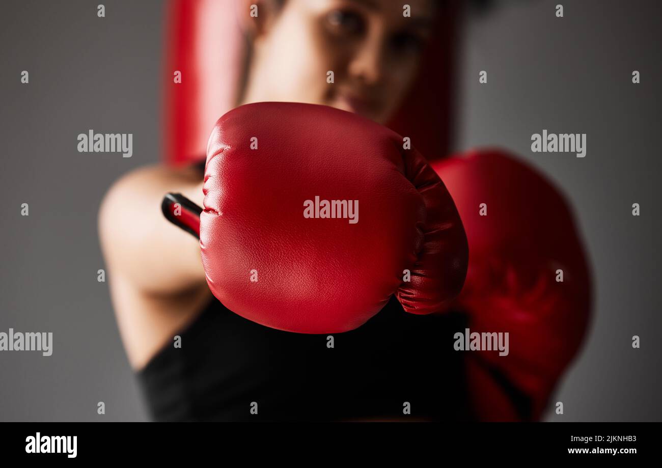 Theres power in those punches. Closeup shot of an unrecognizable young female boxer training in the gym. Stock Photo