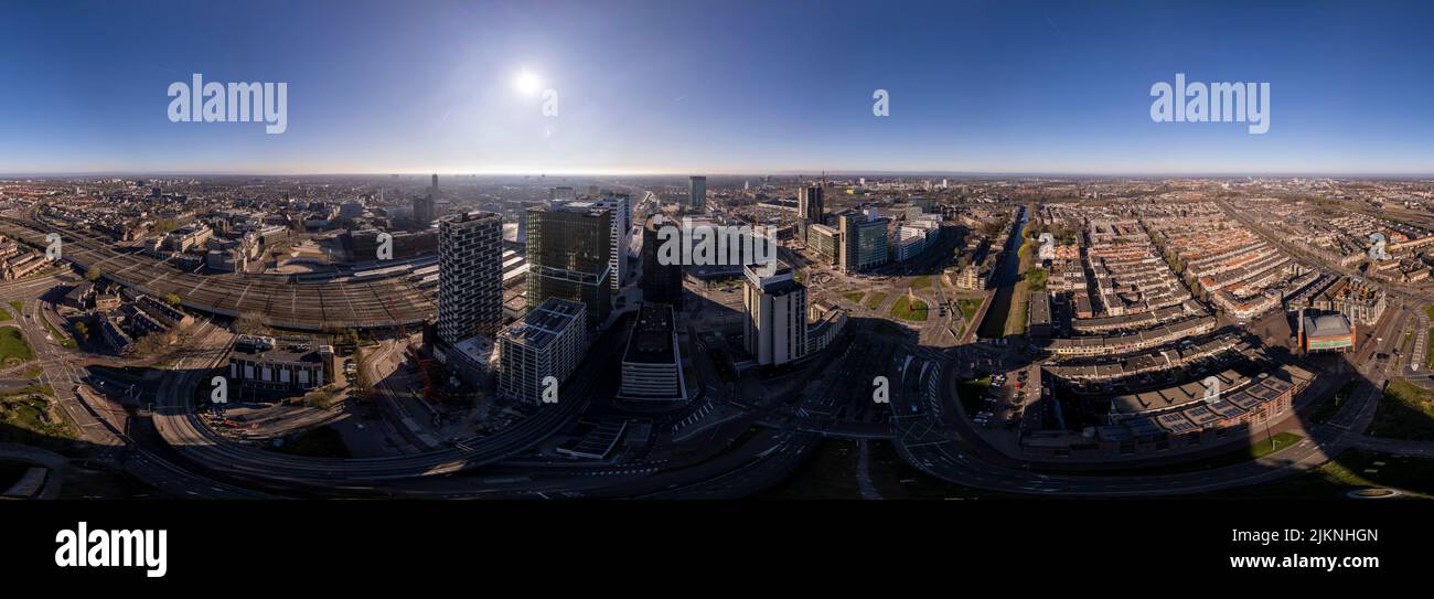 Sunrise aerial 360 degrees panorama over Utrecht central train station infrastructure and financial high rise office buildings Stock Photo