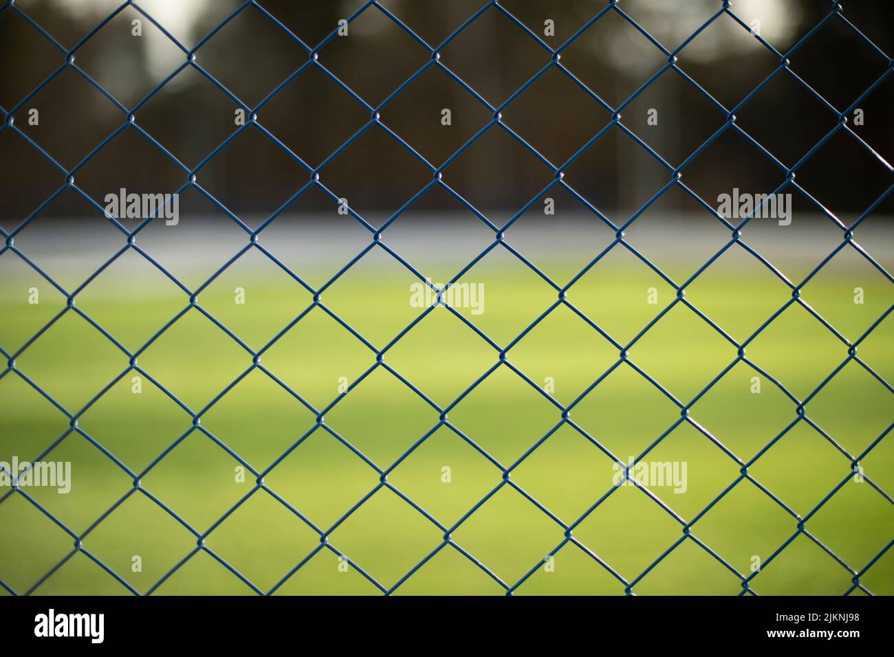 Fence net. Fence on green background. Steel mesh Stock Photo - Alamy