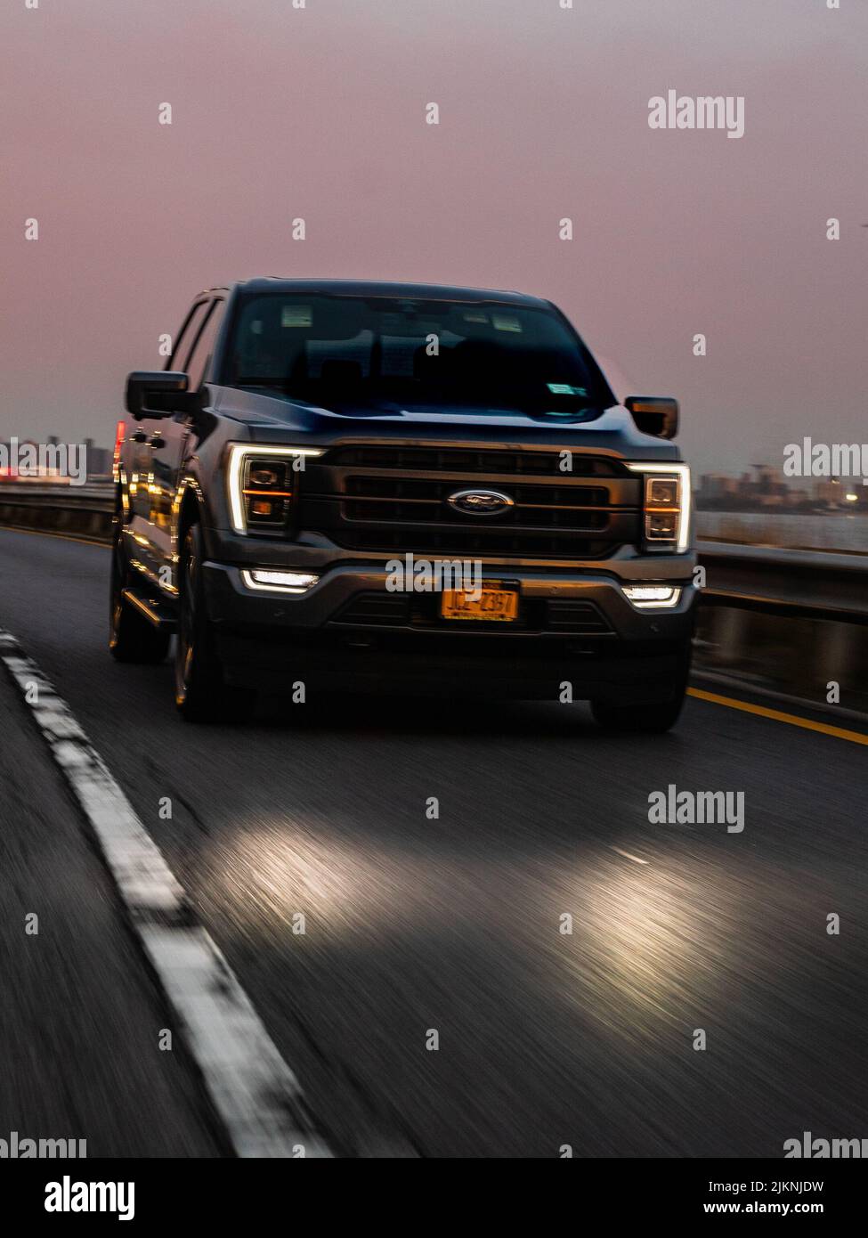 A vertical shot of the beautiful Ford pickup on the Brooklyn Bridge in NYC, The USA Stock Photo