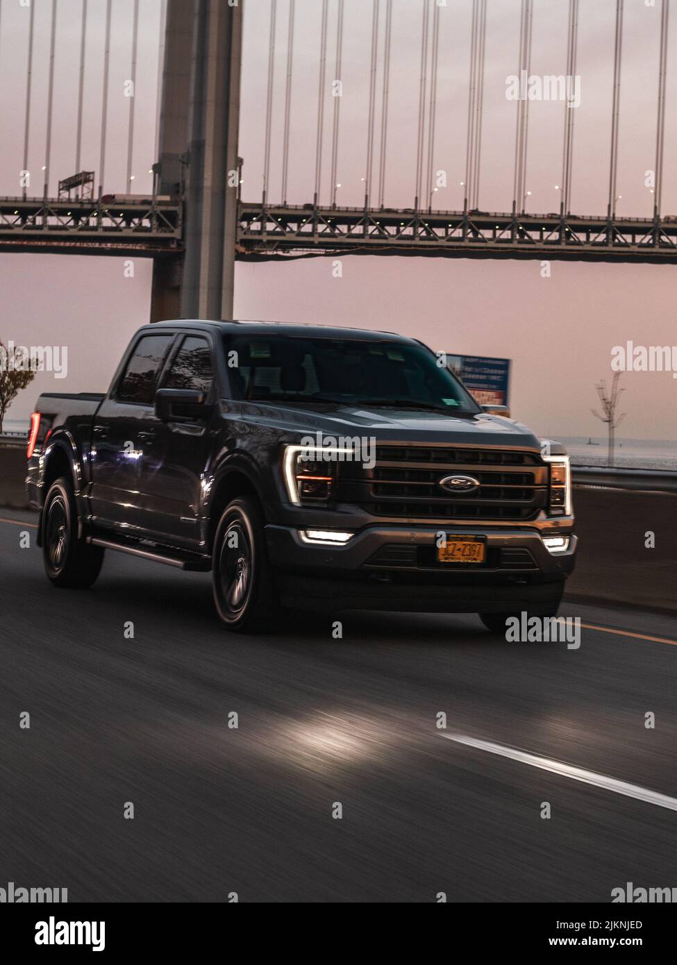 A vertical shot of the beautiful Ford pickup on the Brooklyn Bridge in NYC, The USA Stock Photo