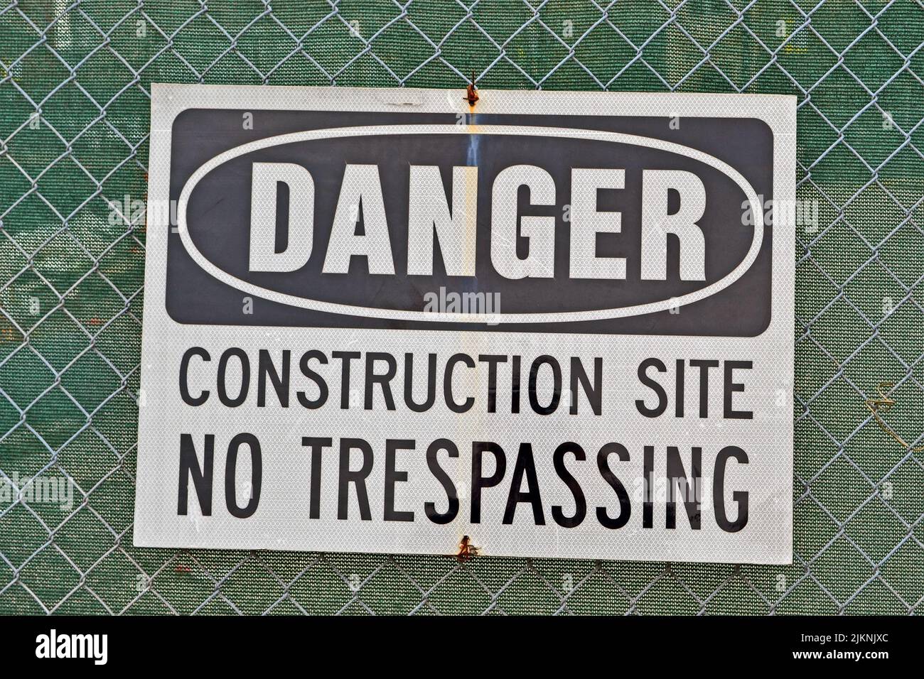 danger, construction site, no trespassing as warning message on metal ...