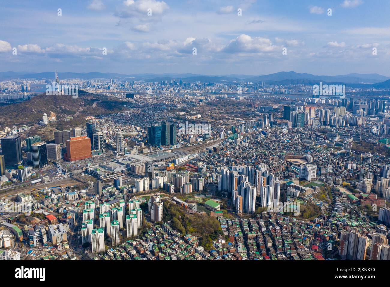 An aerial cityscape of Seoul surrounded by buildings under blue bright sky Stock Photo