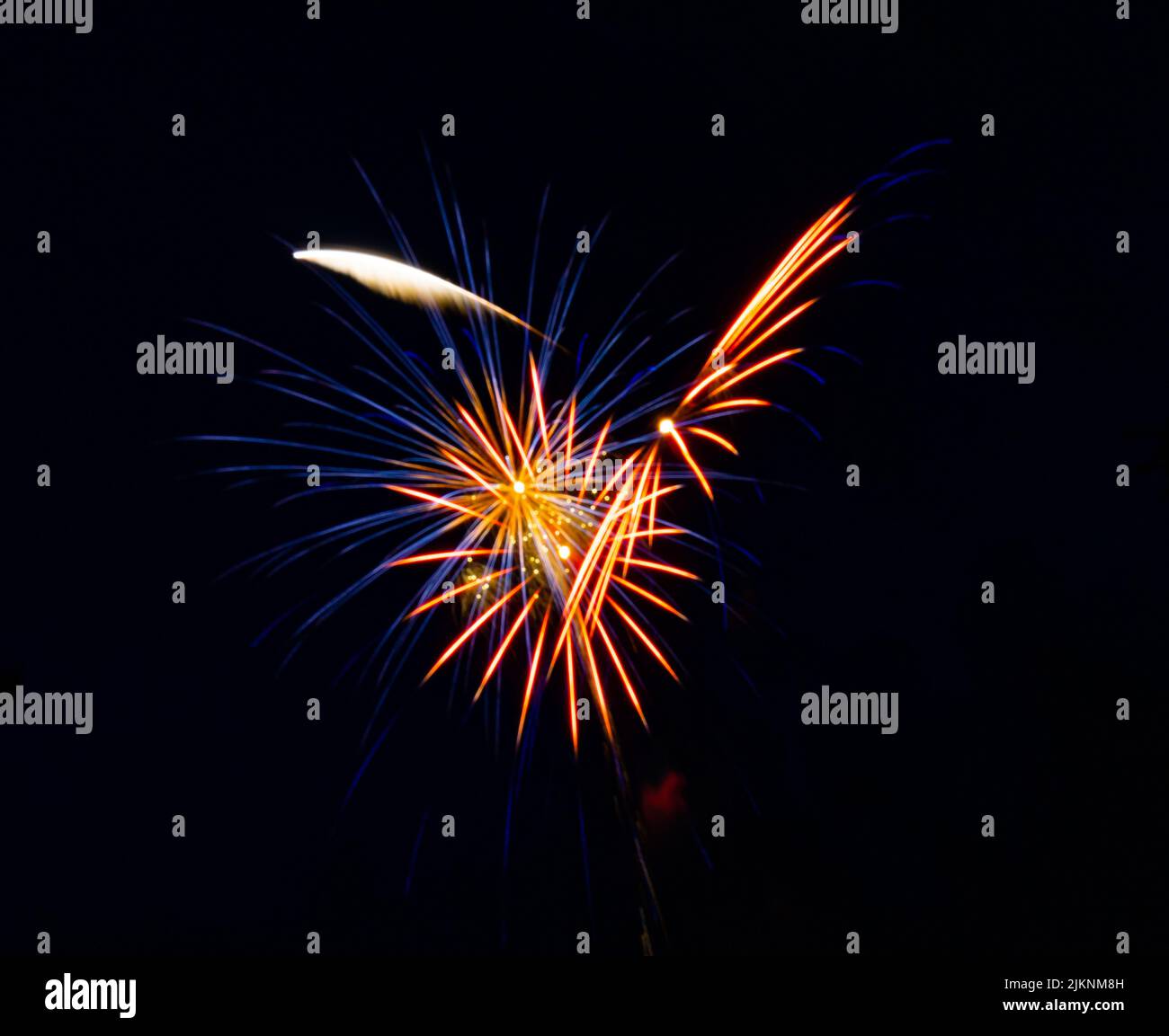 The bright colorful splashes of firework in the dark sky during a ...