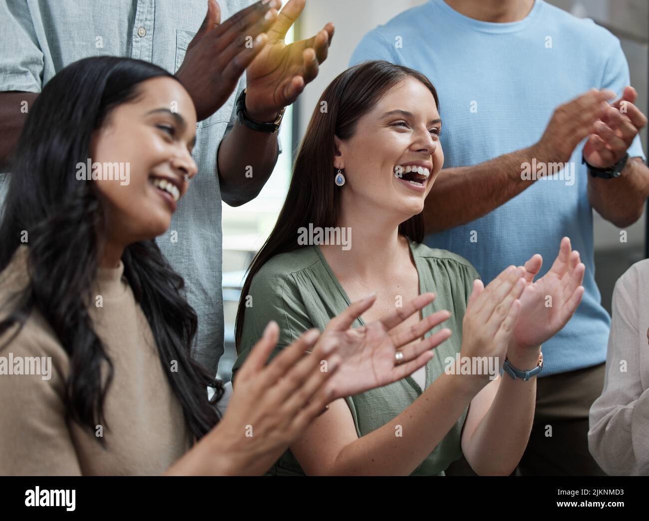 That was highly impressive. a group of businesspeople applauding in an office. Stock Photo