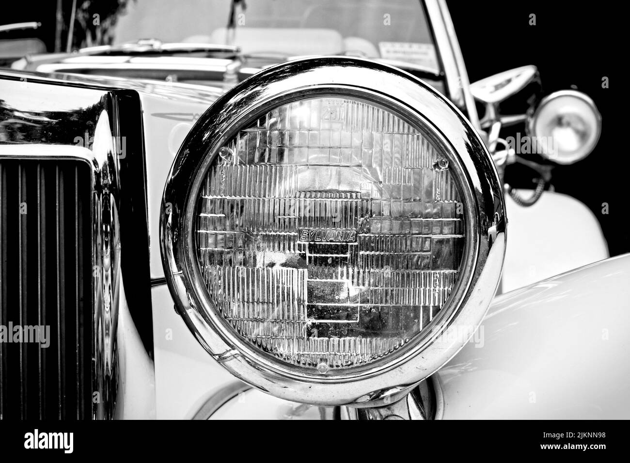 the photo is in black and white and shows a partial front view of a convertiblea lot of chrome adorns the vehicle Stock Photo