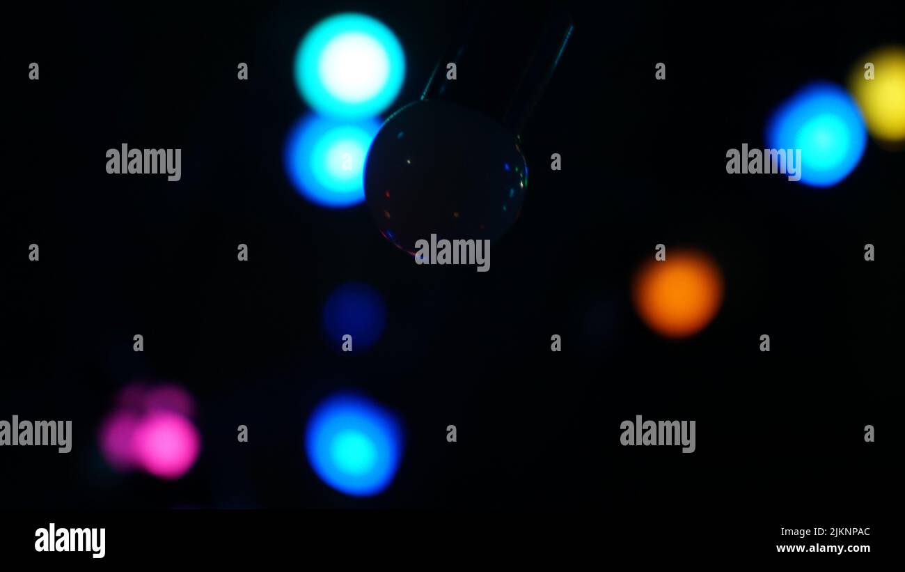 Colorful, glowing lights on the ceiling isolated on a black background Stock Photo