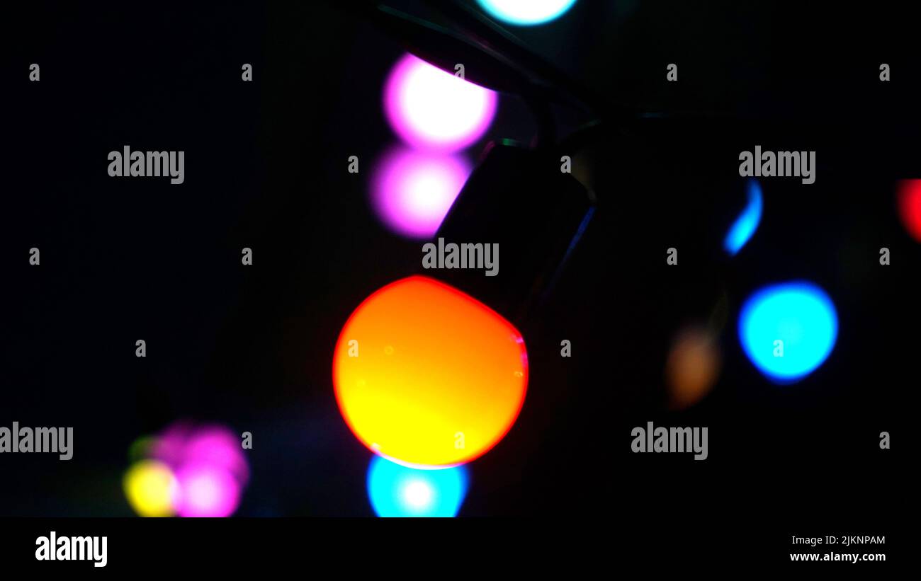 Colorful, glowing lights on the ceiling isolated on a black background Stock Photo