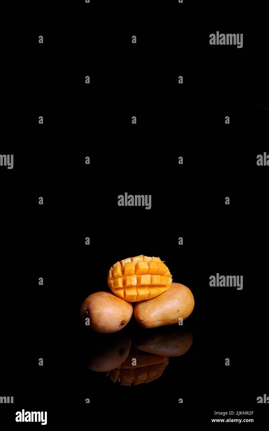 A fresh ripe mango isolated on black background Stock Photo