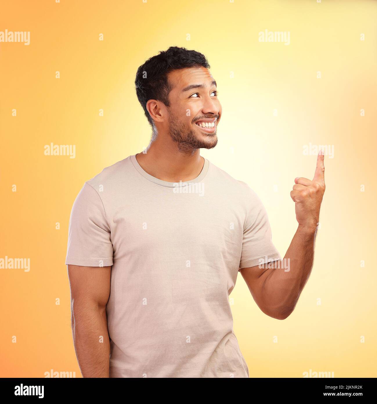 Are you seeing this. a young man pointing at copy space against a yellow background. Stock Photo