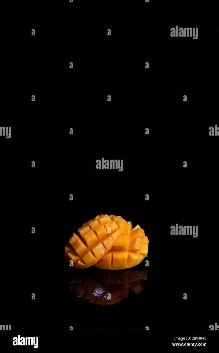A fresh ripe mango isolated on black background Stock Photo