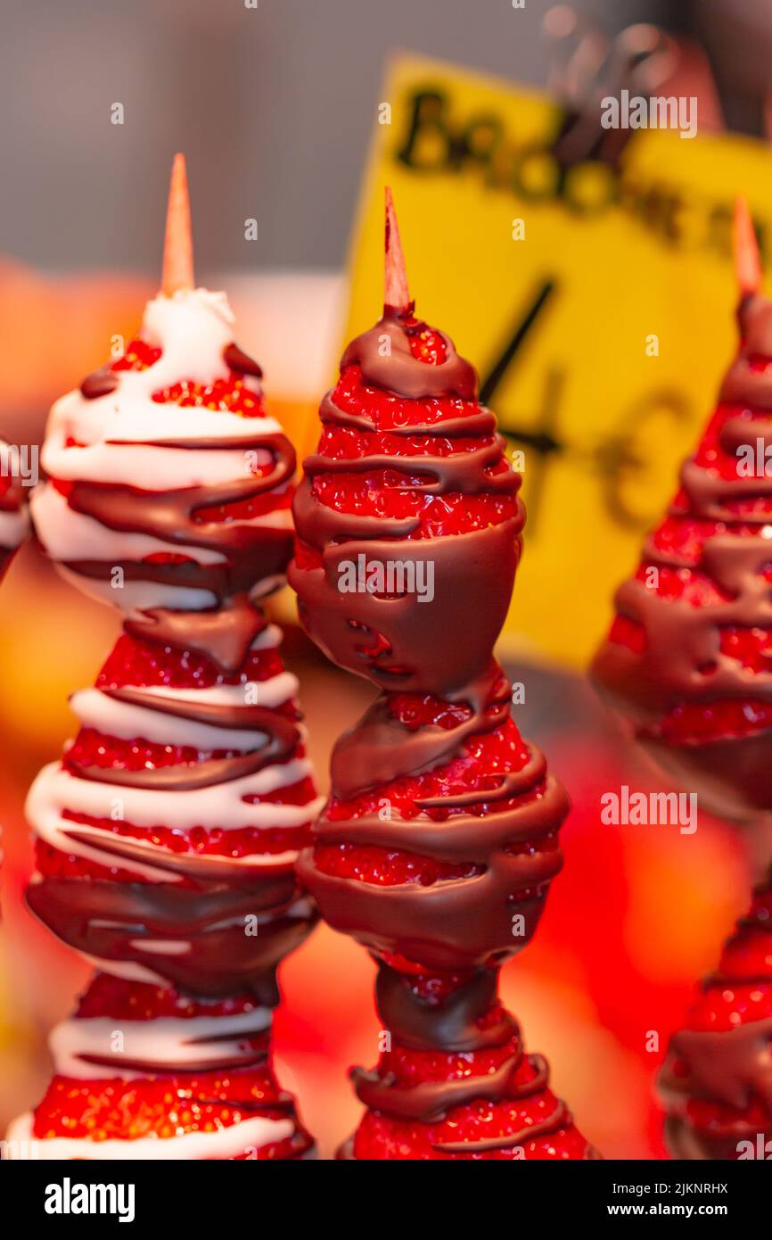 Strawberry brochette dipped in melted chocolate at the Boqueria market