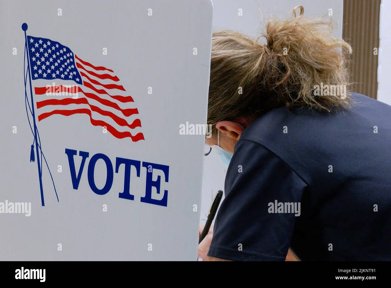 A voter marks a ballot during the primary election and abortion referendum at a Wyandotte County polling station in Kansas City, Kansas, U.S. August 2, 2022.  REUTERS/Eric Cox Stock Photo