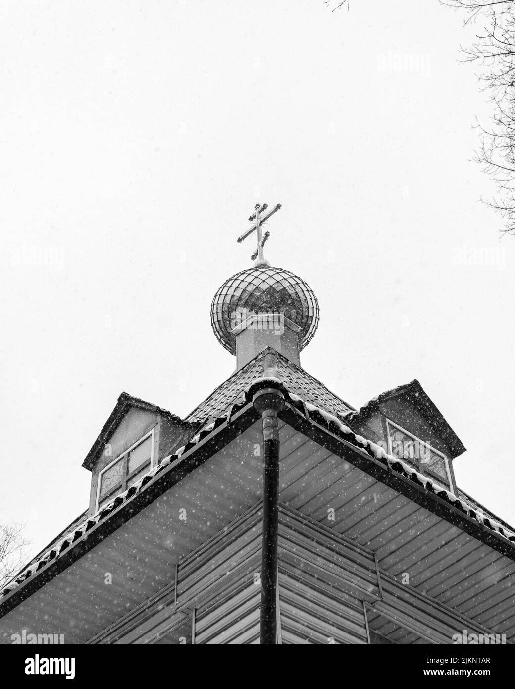 A low angle grayscale shot of a church in the museum of folk wooden ...