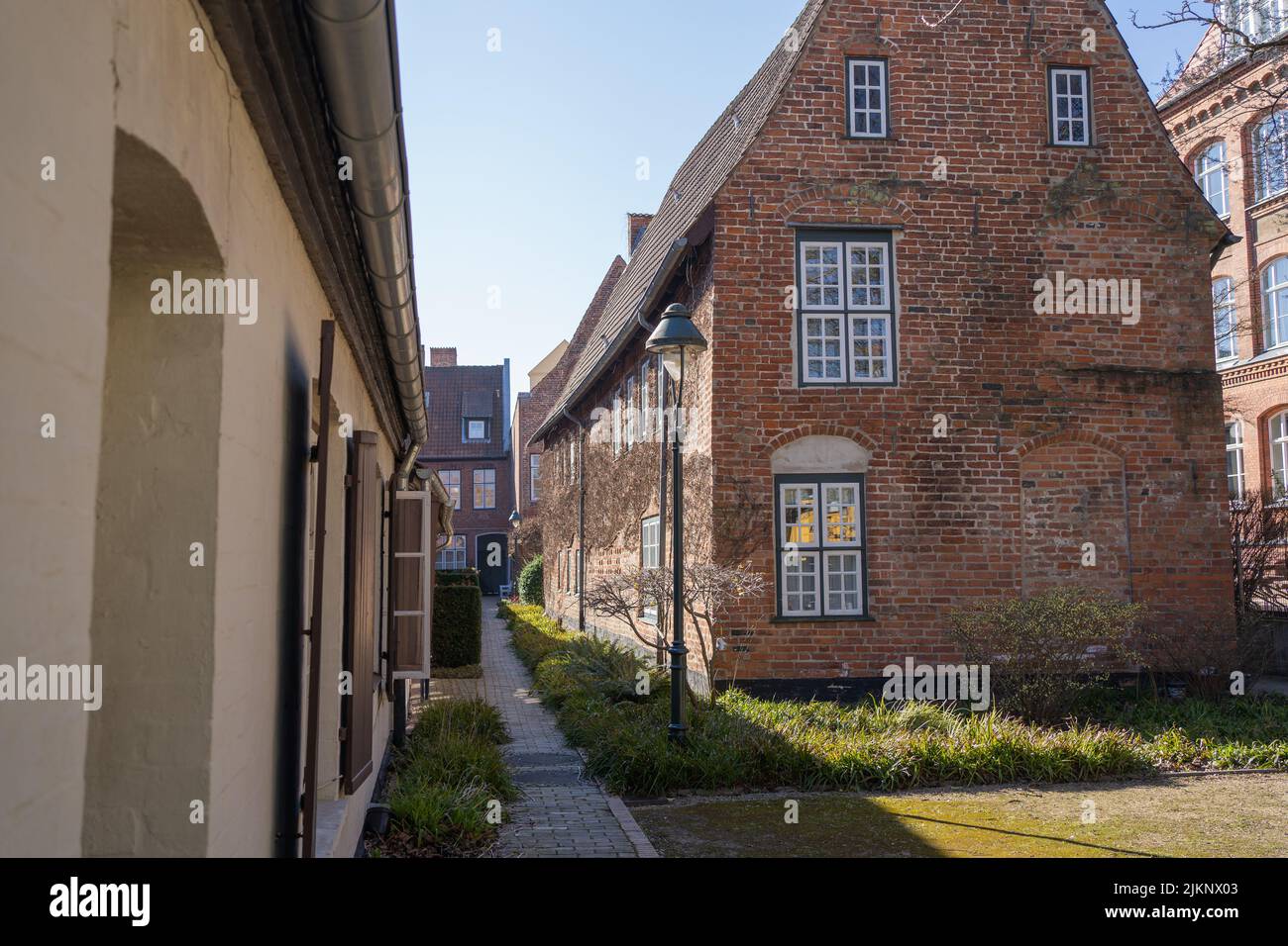 A row of stone historic houses in an alley in Lubeck, Germany Stock Photo
