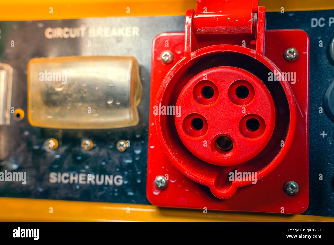 Power outlet with red grounding on the body of a gasoline electric