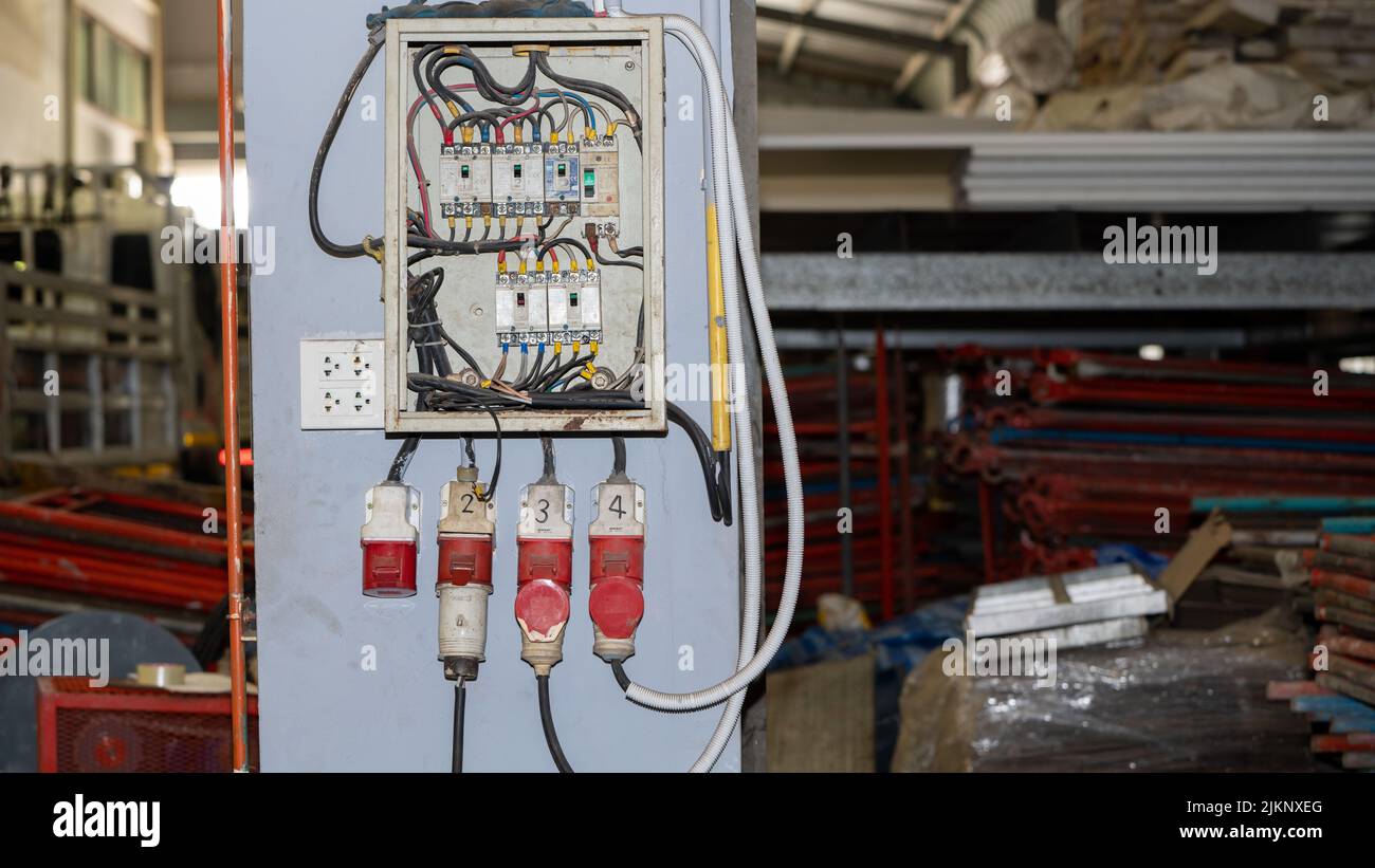 Dangerous Short circuit and damaged blown electricity breaker from high voltage overload in Manufacturing Factory, old grunge messy fuse box and bad i Stock Photo