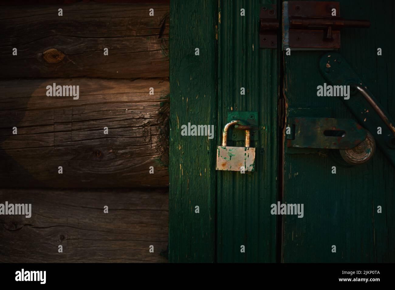 Rusty lock on the old wooden door. Front view. Stock Photo