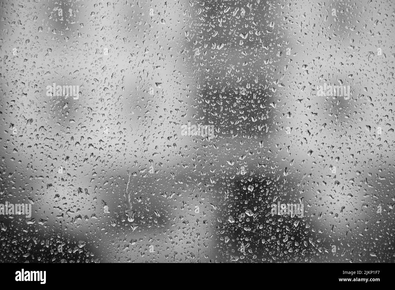 A background of rain drops on window glass on a rainy day Stock Photo ...