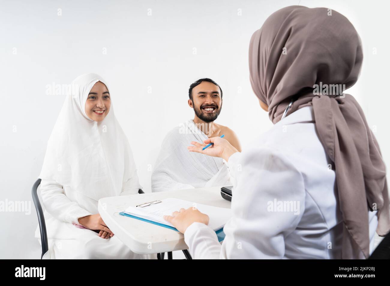 Doctor asks the husband and wife of prospective Hajj pilgrims Stock