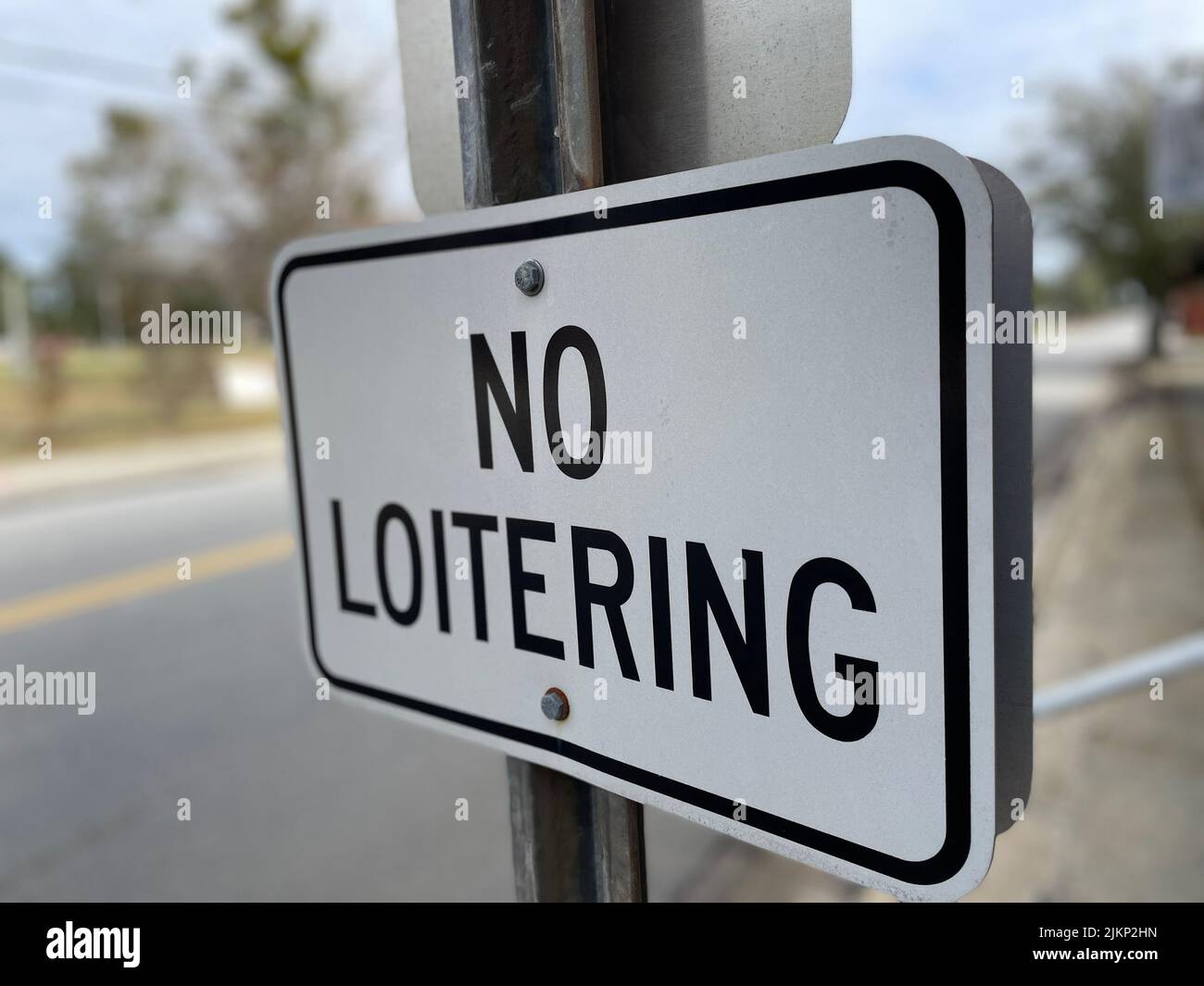 No loitering sign on a post in the country Stock Photo
