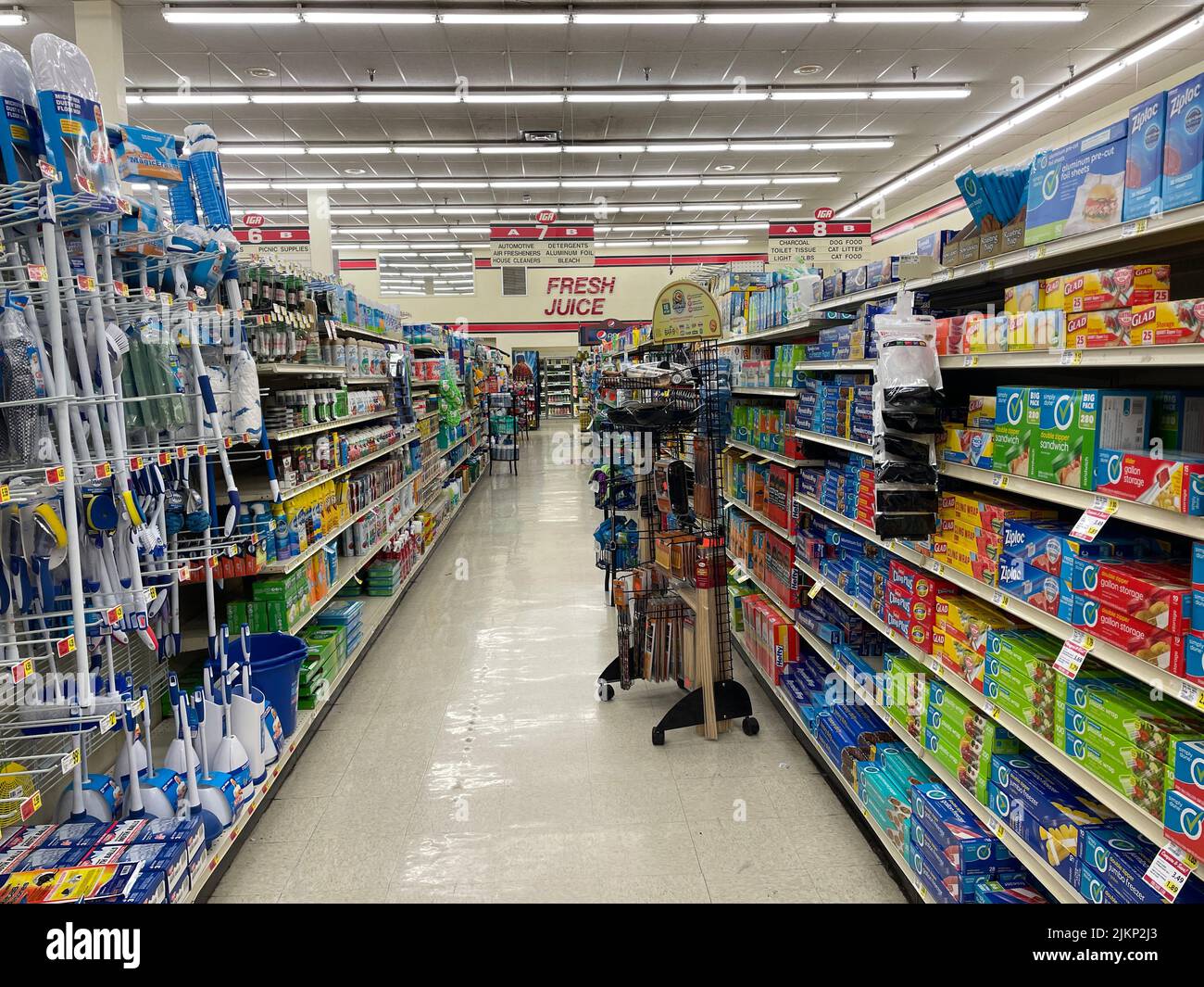 A shot of products in retail grocery store with mops and brooms aisle
