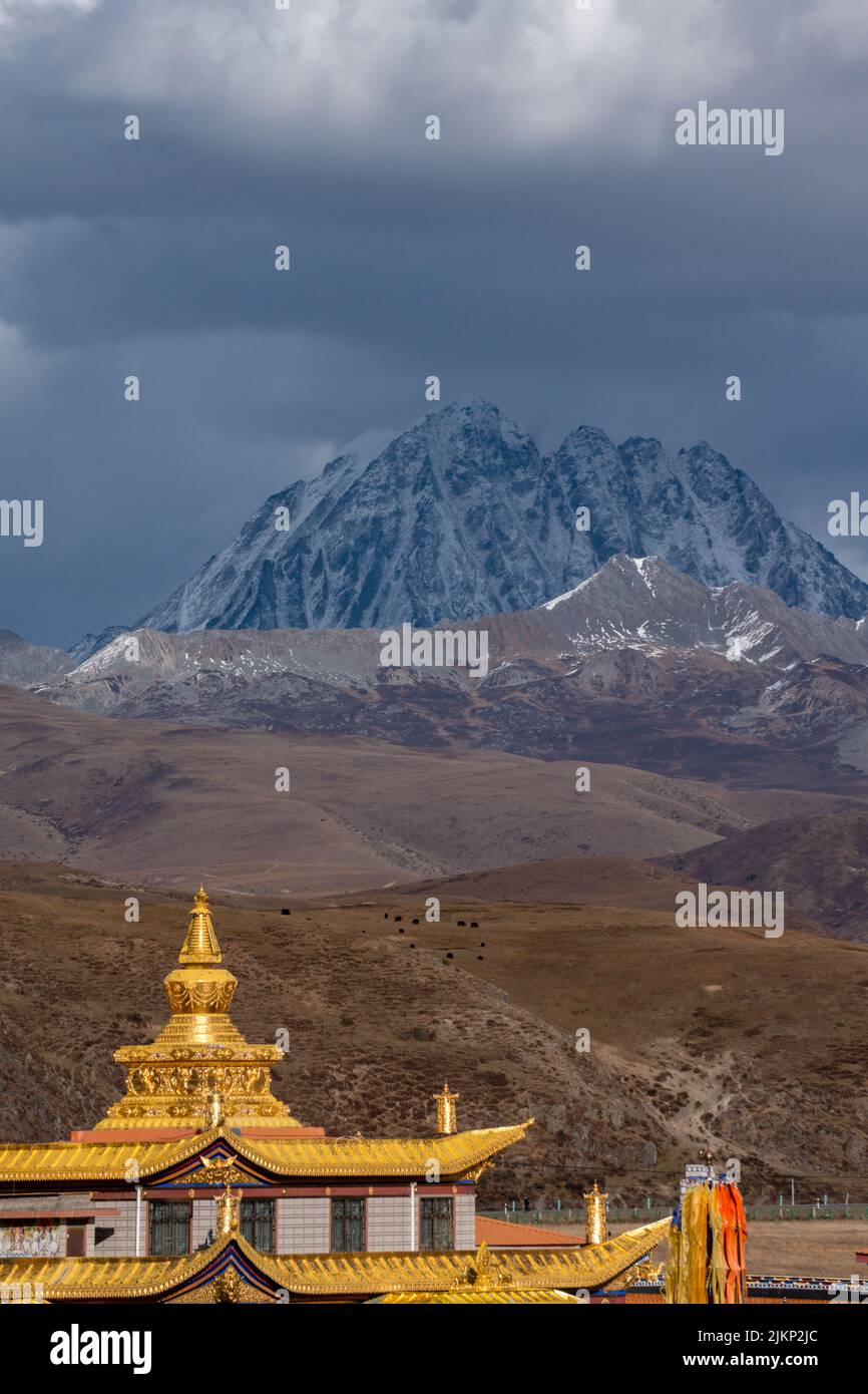 A vertical shot of the famous Muya Golden Tower National park in Garze Tibetan Autonomous Prefecture, China Stock Photo