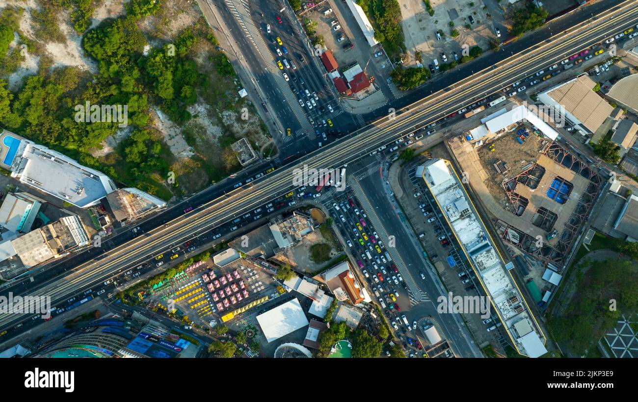 Aerial view Automobile cars drive at cross road in the City Town. Skycrapers buildings at downtown streets. Business center City Roads Traffic road Ju Stock Photo