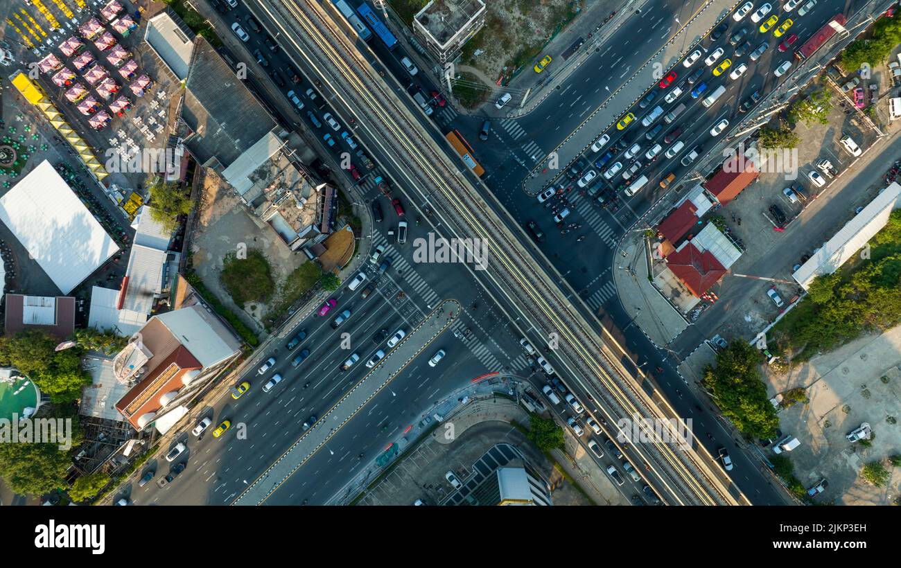 Aerial view Automobile cars drive at cross road in the City Town. Skycrapers buildings at downtown streets. Business center City Roads Traffic road Ju Stock Photo