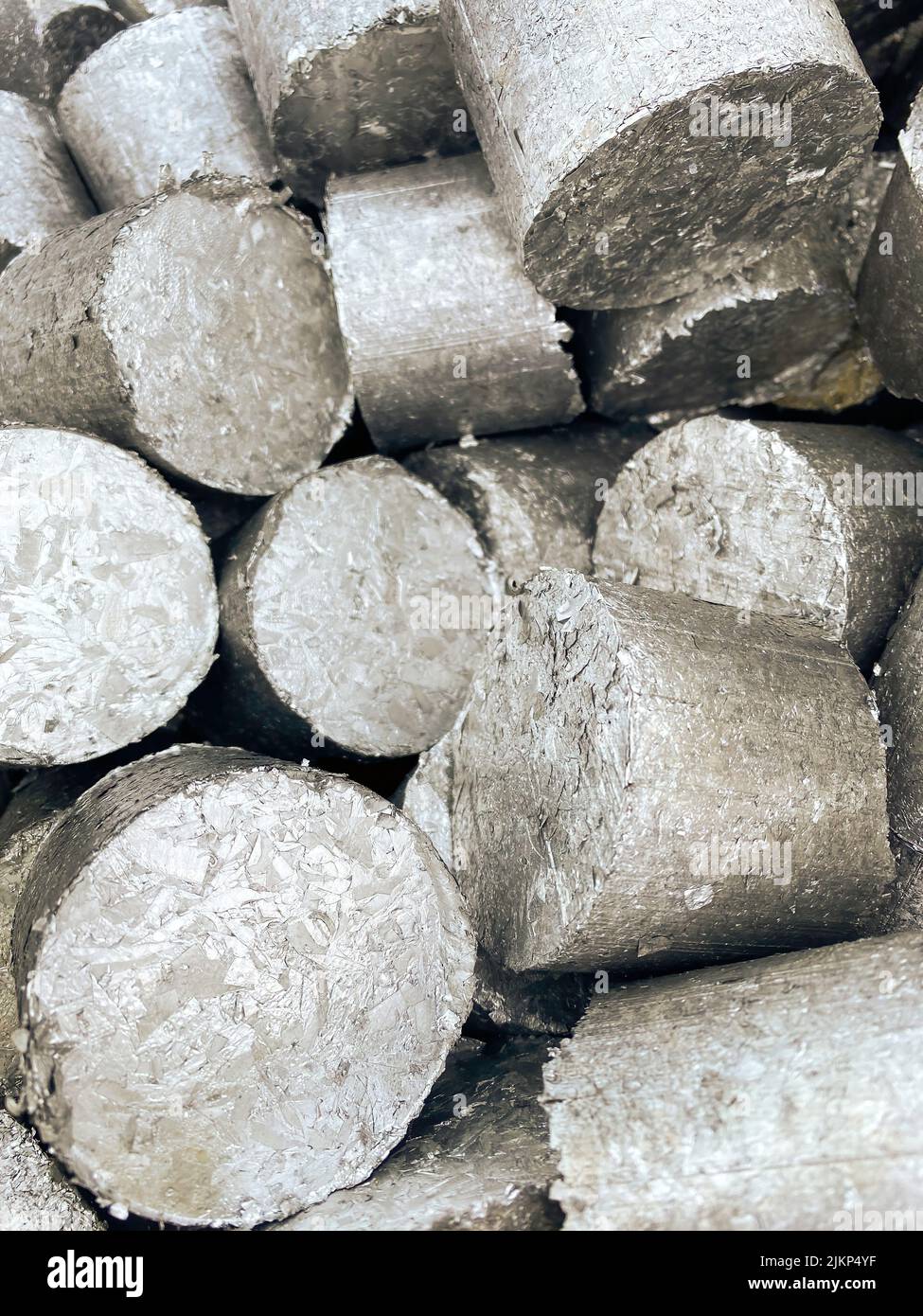 Aluminium compressed turnings called pucks ready to be remelted. High quality image. Stock Photo