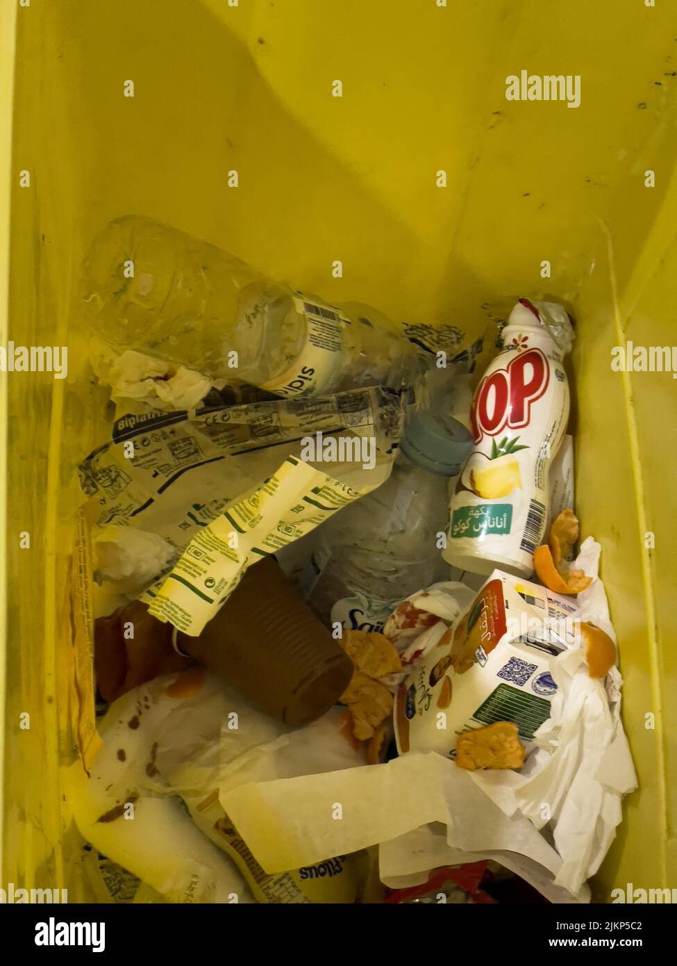 Yellow trash bin full of plastic waste inside a hospital in Morocco